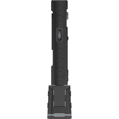 A black flashlight in detail. The body has grooves. A switch is visible.