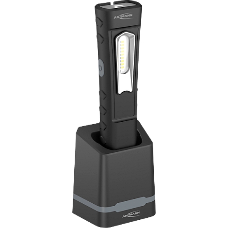Black LED work light in charging station, silver accents, lettering. Rod-shaped design, side fluting.