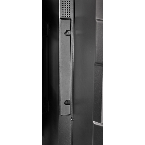 Detailaufnahme einer schwarzen, rechteckigen Platte mit einer Schraube und Löchern an der Oberseite, die an einer dunklen Wand befestigt ist.