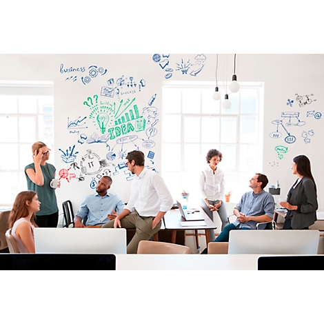 A group of people in the office brainstorming. Diagrams are on the wall and the word "Idea" is written.