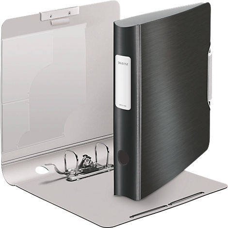 An open black binder stands on a light gray surface. A white label is attached to the side of the binder.