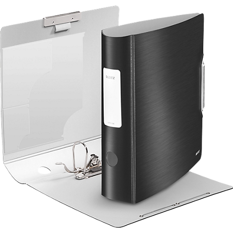 A black file folder stands on an open, light gray folder. The file folder has a white sticker with text.
