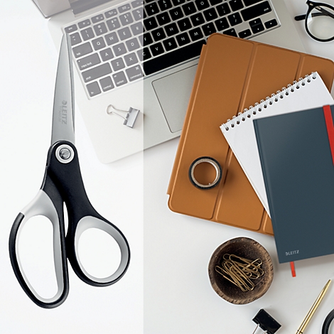Ciseaux, carnet, stylo, ruban adhésif et ordinateur portable sur fond blanc.