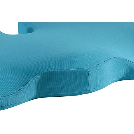 Gros plan d'un coussin turquoise avec des bords incurvés et un élément carré.