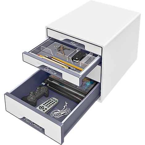 White drawer cabinet with open drawers. Contents: keys, pens, remote control, controller, CDs, and cables.