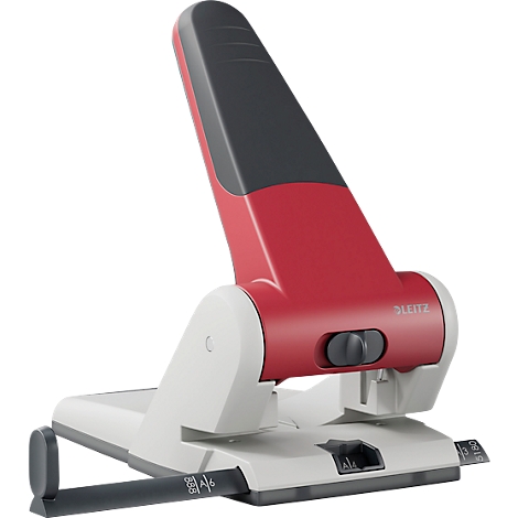 A red and white hole punch with a gray lever that says "LEITZ".