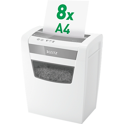 White paper shredder with paper shreds. Paper with green print "8x A4" is fed in at the top.