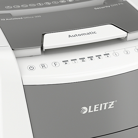 Close-up of a gray paper shredder with white elements. The inscription 'Automatic' is clearly visible.