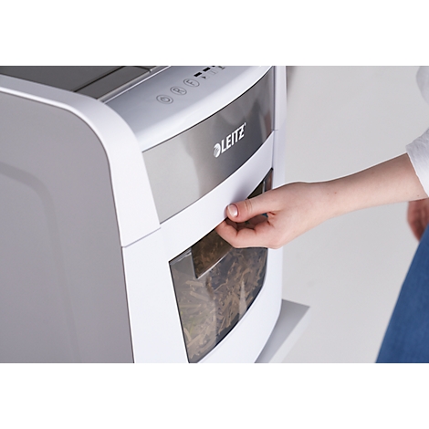 A hand opening a paper tray on a white shredder. The Leitz logo is visible.