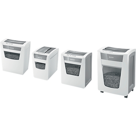 Four white paper shredders side by side. Paper shreds are visible through transparent windows. Gray controls.