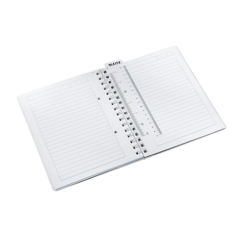 An open notebook with a ruler used as a bookmark. The ruler has the lettering "Leitz".