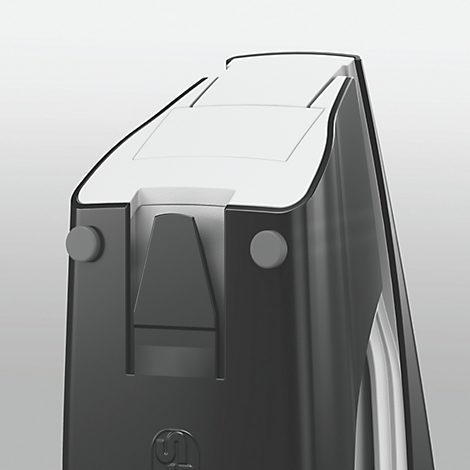 Close-up of a black device. White rectangle on top, gray buttons on the side.