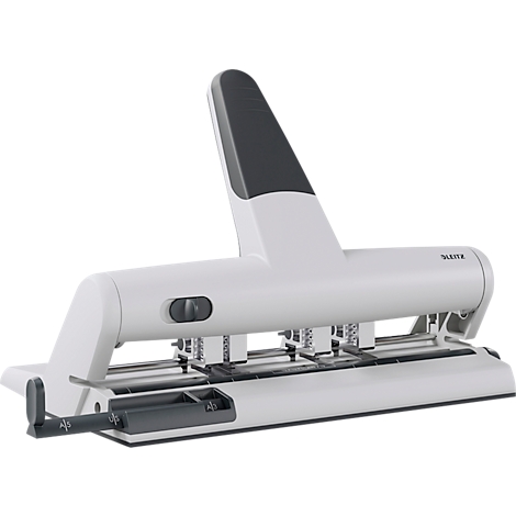 White and grey hole punch with a darker handle. Three punch heads in the center, manufacturer Leitz.
