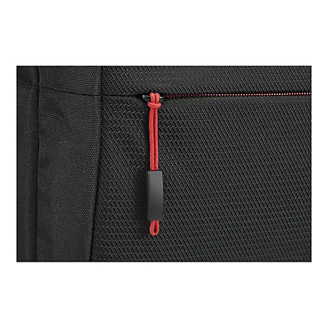 Gros plan sur une surface textile noire avec fermeture éclair rouge et tirette.