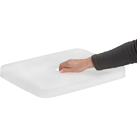 A hand reaches into a white, rectangular plate with a hole. The arm is dressed in a gray sweater.