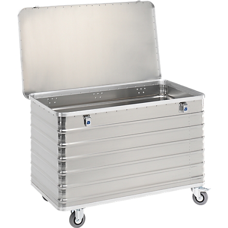 A silver transport box with an open lid, on wheels. The box has horizontal grooves and two blue latches.