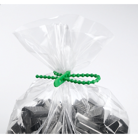 A transparent plastic bag, closed with a green cord closure. The bag contains dark objects that are not further identifiable.