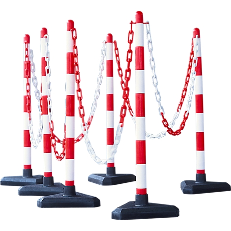 Six red and white striped barrier posts with chains, set up for demarcation.