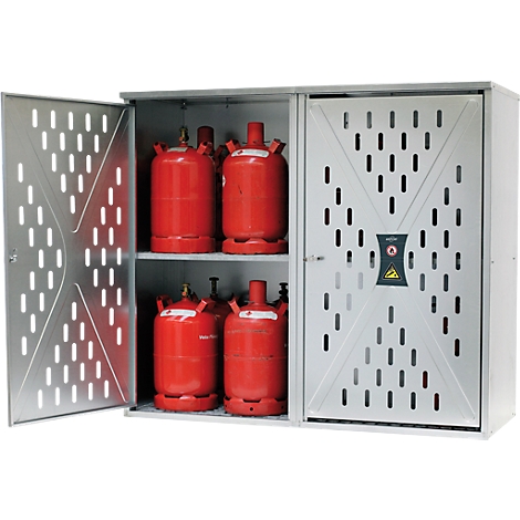 Grey cabinet with red gas cylinders. The left door is open, the right one closed with warning signs.