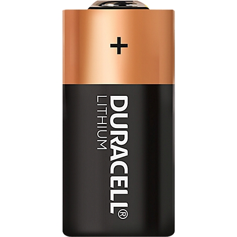 Cylindrical Duracell lithium battery with copper and black surfaces. The plus sign and the lettering "DURACELL LITHIUM" are visible.