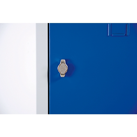 Detail shot of a blue cabinet with a silver handle. The door is on the right, a white wall on the left.