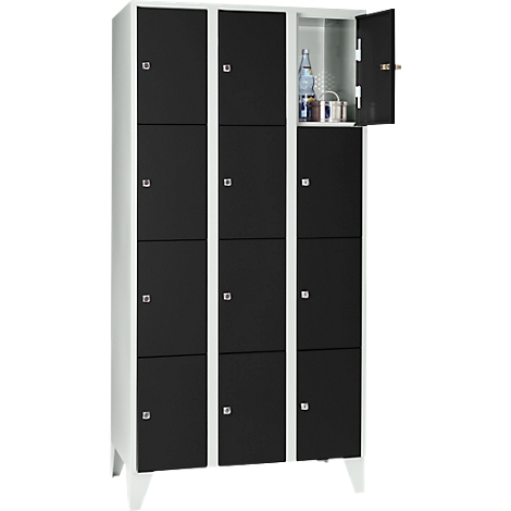 Black locker with white frame. One door is open, showing a bottle and some containers.