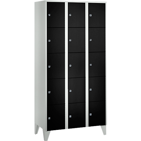 Cabinet with nine black doors, white frames, standing on four white feet. Shiny door handles.