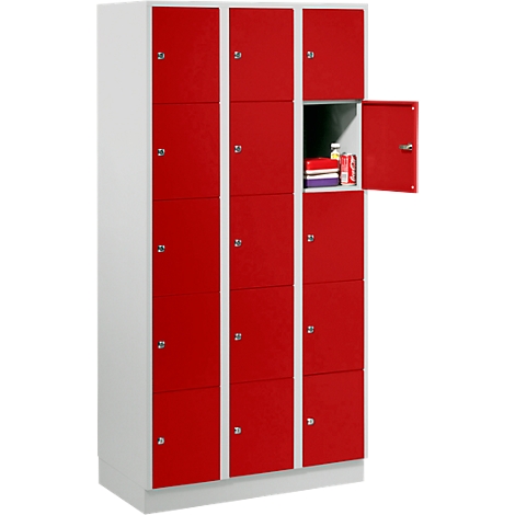 Red locker with 12 compartments, one compartment open. Storage of books and snacks.
