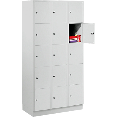 A grey locker with an open door filled with books and drinks.