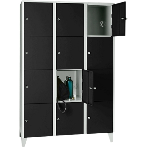 Black lockers with opened doors containing objects.