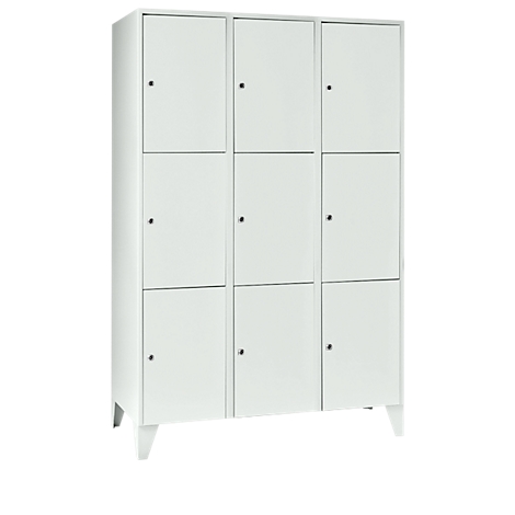 A white cabinet with nine doors and small knobs. The cabinet stands on four feet.