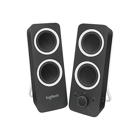 Zwei schwarze Logitech-Lautsprecher mit weißen Rändern und zwei Lautsprecheröffnungen. Rechts: Drehknopf und Anschlüsse.