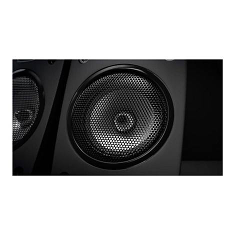 Gros plan sur un haut-parleur noir avec une grille métallique. L'accent est mis sur le grand haut-parleur rond avec une grille en nid d'abeille.