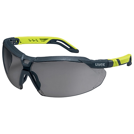 Lunettes de sécurité gris-bleu, branches jaunes. "uvex" est écrit sur une branche.
