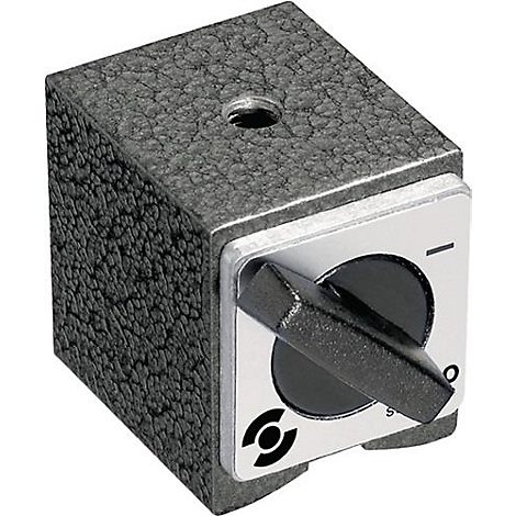 Een vierkante, grijze magnetische voet met textuur, met een draaiknop en een metalen bedieningspaneel. Er zit een gat bovenop.