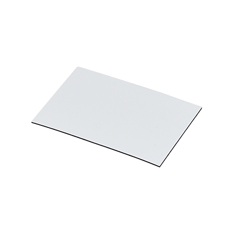 Rectangular, white paper with black edge. Lying diagonally in the picture.
