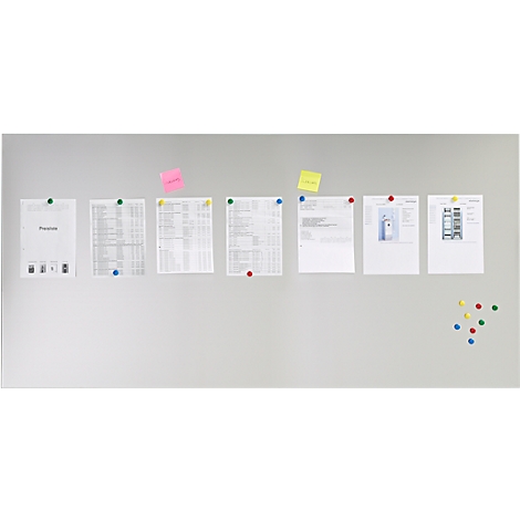 Gray wall with papers and notes. Papers and sticky notes with colorful thumbtacks attached to the wall.