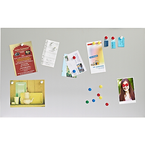 A magnetic notice board with notes, photos and colorful magnets. Invitations, restaurant advertisements and a photo of a smiling woman.