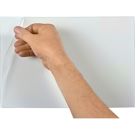 A hand is peeling a protective film off a white surface.
