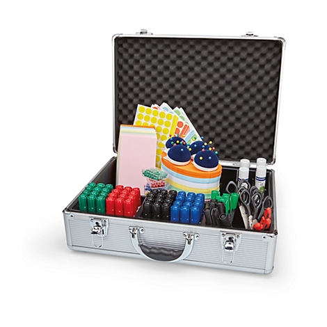 Open silver suitcase filled with school supplies. Contains papers, pincushions, markers, scissors, and glue.
