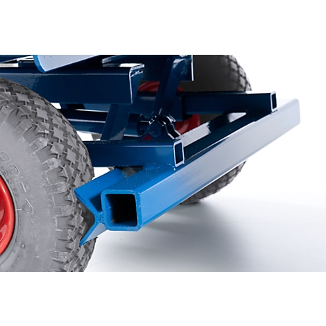 Close-up of a blue metal frame with a wheel in the background. A red circle is visible in the wheel.