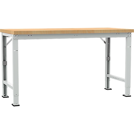 Wooden workbench with light grey metal legs. The table stands on black feet.