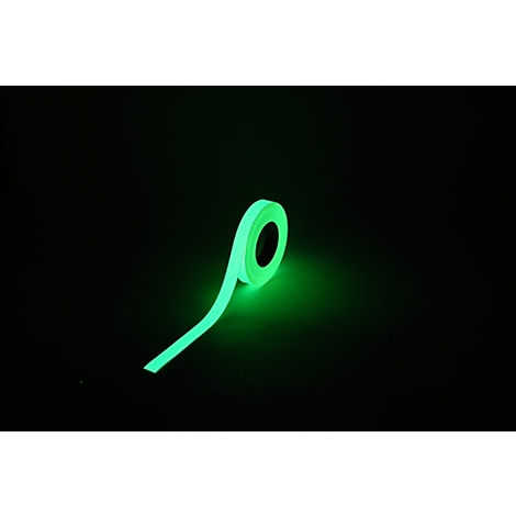 Glowing tape roll. Green tape on a black background, glows in the dark.