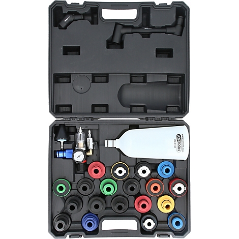 Ein offener schwarzer Werkzeugkoffer. In diesem sind verschiedene Werkzeuge und Aufsätze, darunter farbige Gummiteile und ein weisser Behälter.