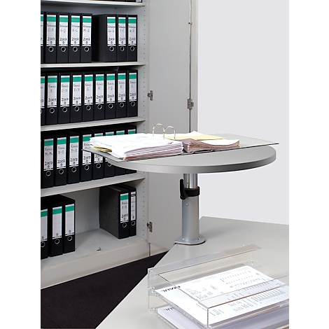 Cabinet with file folders and an extendable table with papers on it.