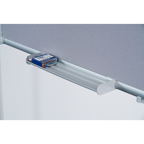 Close-up of a pinboard with a pen holder. There are drawing pins in a box.