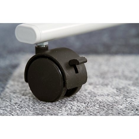 Close-up of a black furniture wheel with locking lever. Above, a white furniture leg.