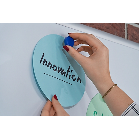 Handen plaatsen blauwe cirkels op een bord. Eén cirkel zegt "Innovatie."