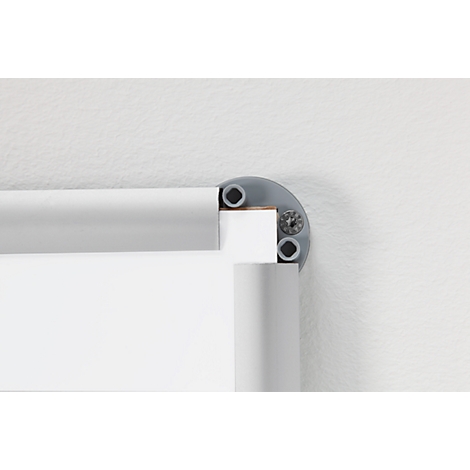 Corner of a frame, light gray. Corner joint with screws. Background: white wall.
