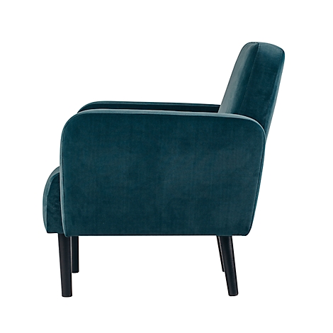 Petrolkleurige fauteuil, zijaanzicht. Donkere houten poten, fluwelen stof.